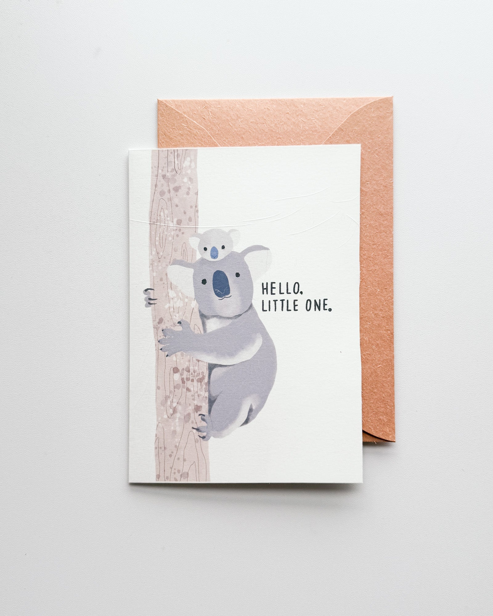 Greeting card with a koala illustration and 'Hello, Little One' text on a white background.